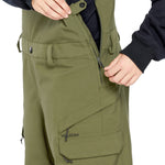 Volcom Women's Creston 3D Stretch Bib Overall - Olive green bib overalls with a zip front and adjustable straps.