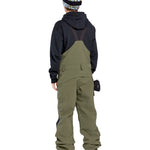 Volcom Women's Creston 3D Stretch Bib Overall - Olive green bib overalls with a black waistband and belt loops, featuring a zip fly and button closure.
