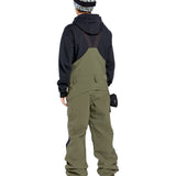 Volcom Women's Creston 3D Stretch Bib Overall - Olive green bib overalls with a black waistband and belt loops, featuring a zip fly and button closure.