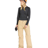 Volcom Women's Frochickie Insulated Pant - A pair of tan snow pants with a small white logo on the left thigh and a black zipper pull.