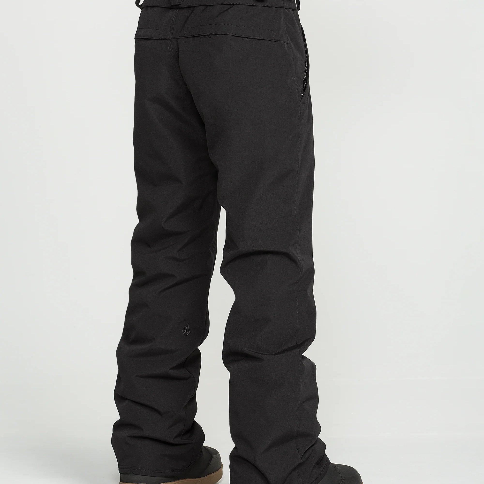 Black insulated snowboard pants with adjustable waist strap and padded cuffs