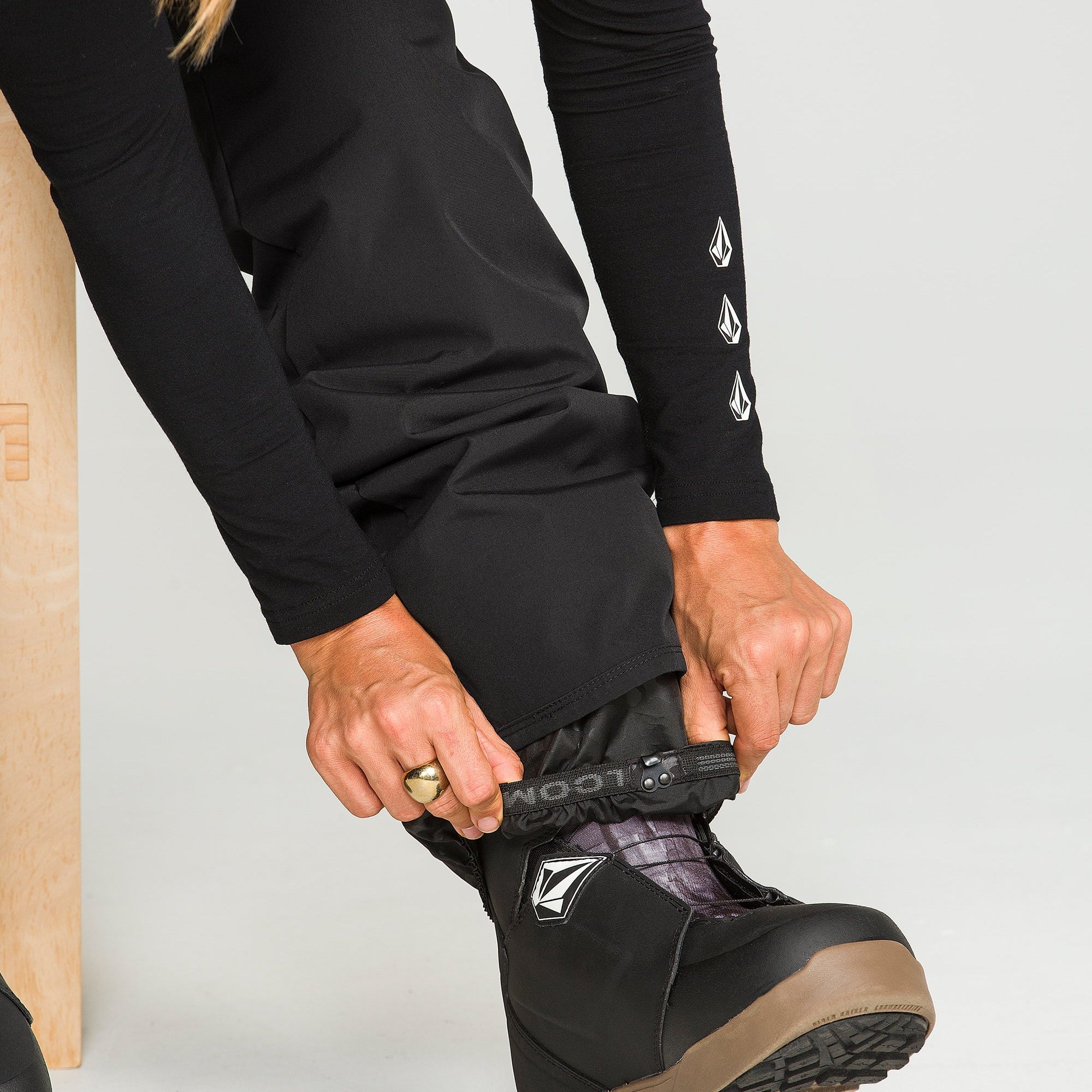 Black insulated snow pants with articulated knees and Velcro cuff adjustment