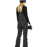 Volcom Women's Elm Stretch GORE-TEX Bib Overall - A black bib overall with a white logo on the left chest and a zippered pocket on the right thigh.