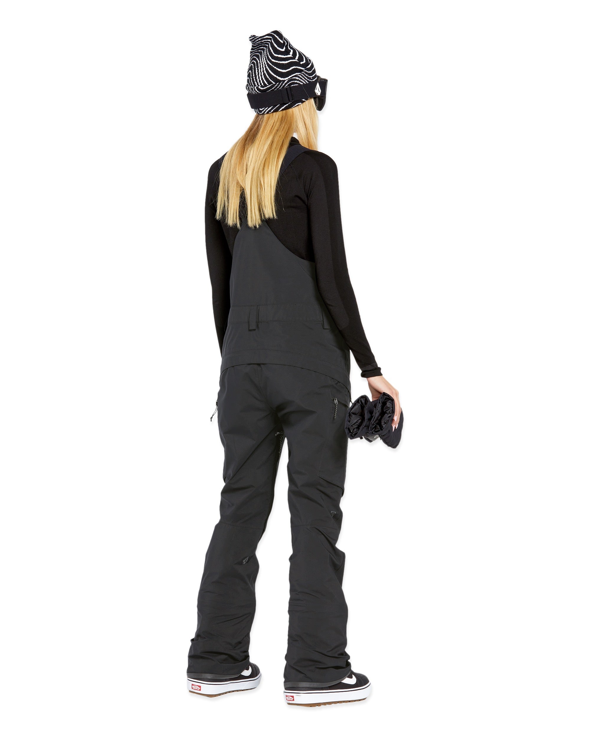 Volcom Women's Elm Stretch GORE-TEX Bib Overall - A black bib overall with a white logo on the left chest and a zippered pocket on the right thigh.