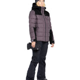 Volcom Women's Elm Stretch GORE-TEX Bib Overall - A woman wearing a black bib overall with a zippered fly and adjustable straps, paired with a matching black jacket and gloves.