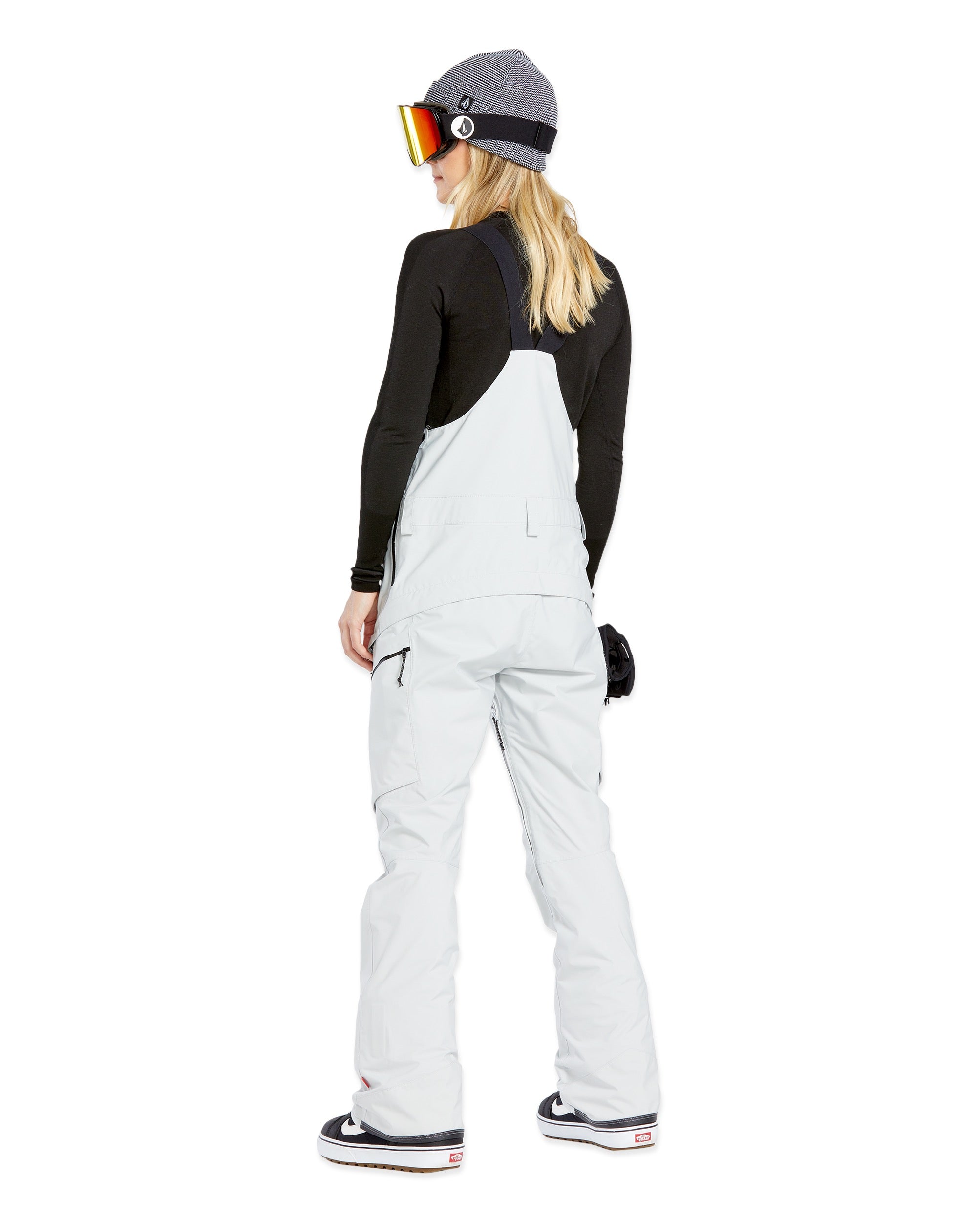 Volcom Women's Elm Stretch GORE-TEX Bib Overall - A pair of white snow pants with a black strap and zipper on the side, featuring a small pocket on the thigh.