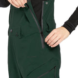 Volcom Women's Elm Stretch GORE-TEX Bib Overall - A dark green bib overall with a black zipper and snap buttons, featuring a stretchy material.