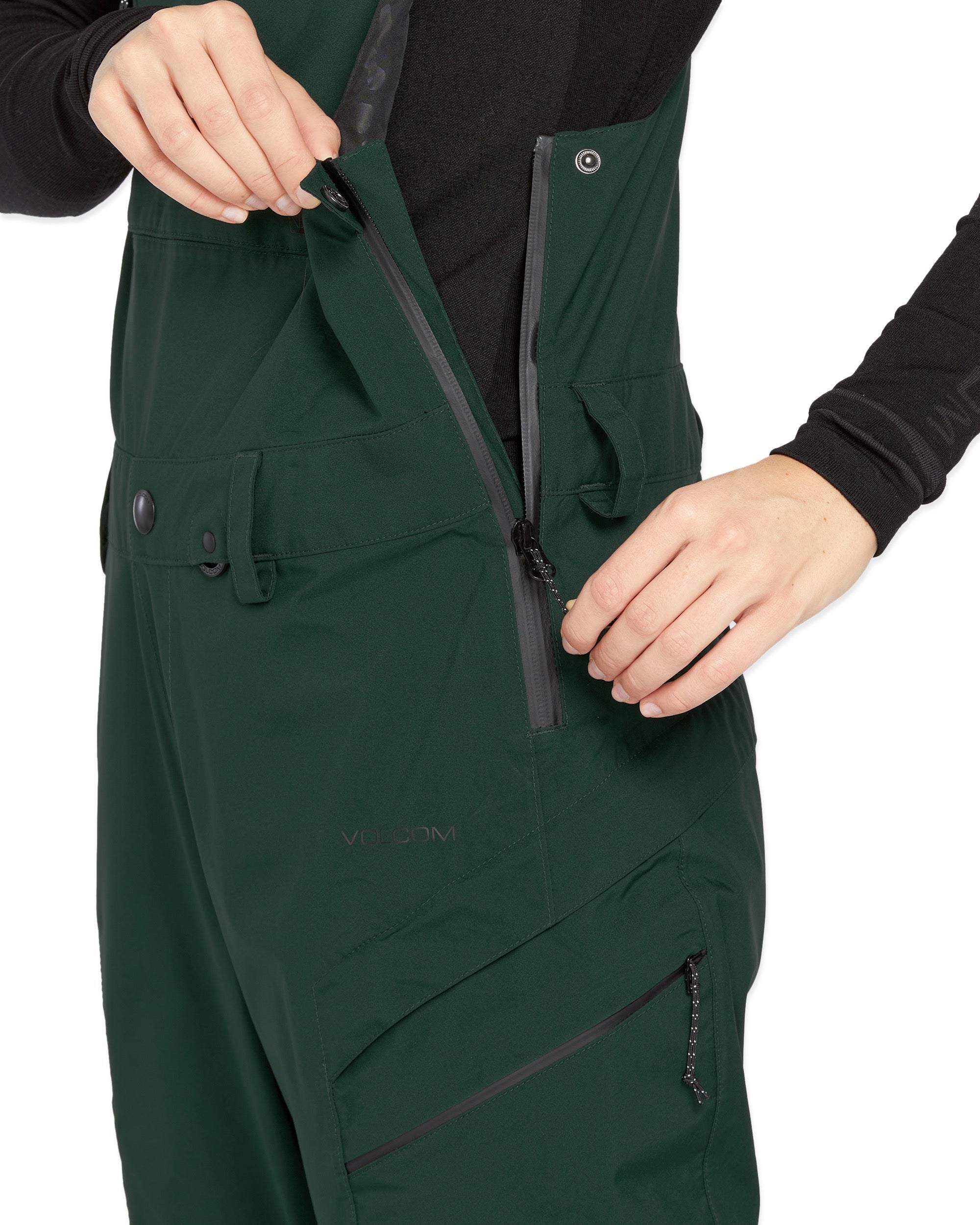 Volcom Women's Elm Stretch GORE-TEX Bib Overall - A dark green bib overall with a black zipper and snap buttons, featuring a stretchy material.