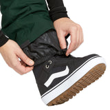 Volcom Women's Elm Stretch GORE-TEX Bib Overall - A pair of black waterproof overalls with a white logo on the left thigh and a zippered pocket on the right side.