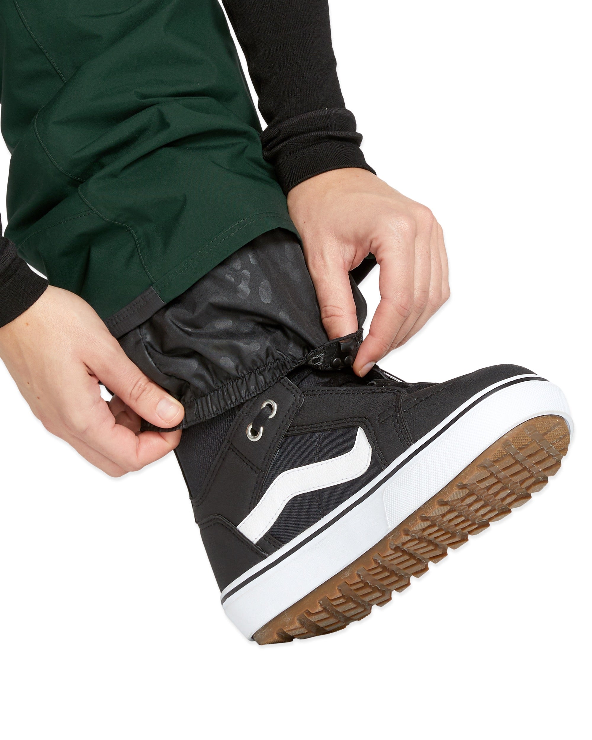 Volcom Women's Elm Stretch GORE-TEX Bib Overall - A pair of black waterproof overalls with a white logo on the left thigh and a zippered pocket on the right side.