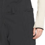 Volcom Women's Swift Bib Overall - A black bib overall with a zippered front and two side pockets, featuring a subtle "VOLCOM" logo on the left thigh.