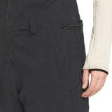 Volcom Women's Swift Bib Overall - A black bib overall with a zippered front and two side pockets, featuring a subtle "VOLCOM" logo on the left thigh.