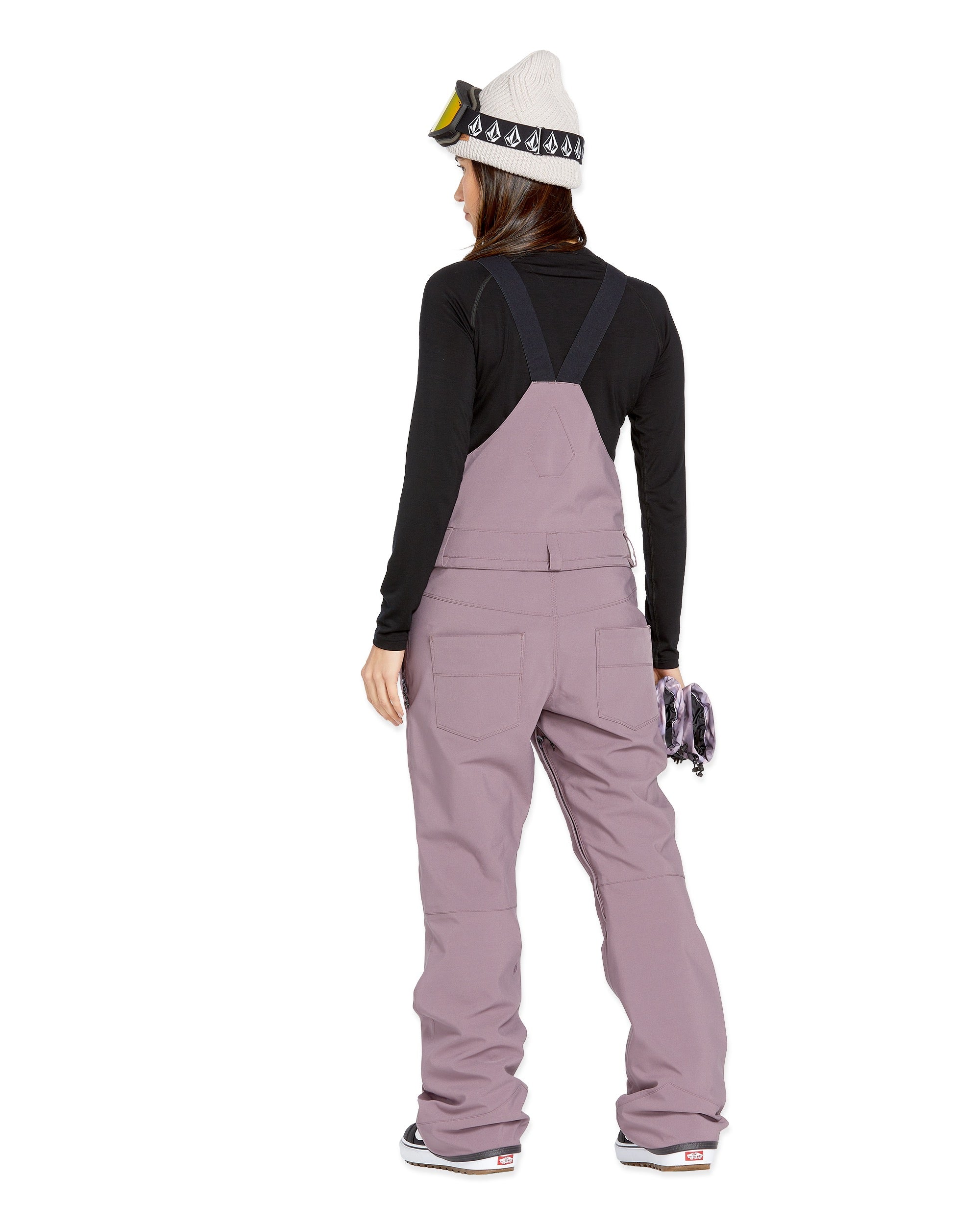 Volcom Women's Swift Bib Overall - A dusty rose bib overall with two front pockets and a zippered fly, featuring adjustable straps and a relaxed fit.