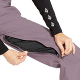 Volcom Women's Swift Bib Overall - A dusty rose-colored bib overall with a zippered fly and adjustable straps.