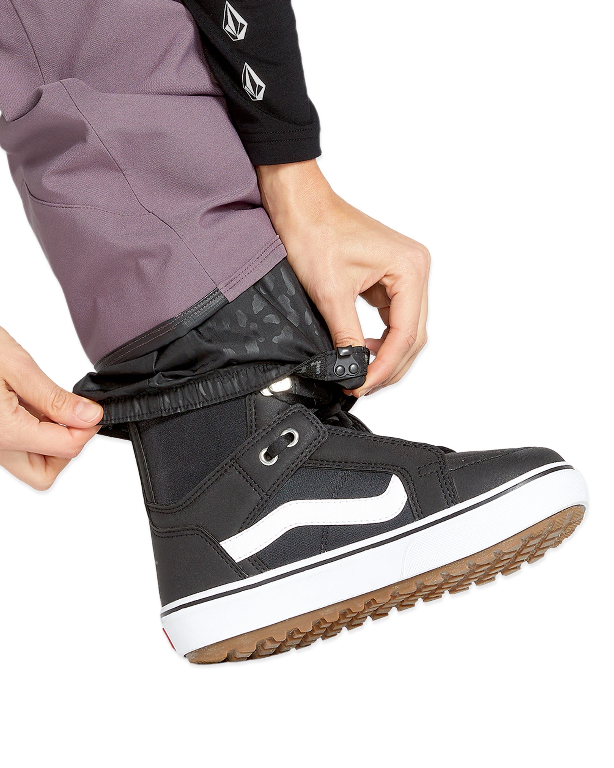 Volcom Women's Swift Bib Overall - A pair of black bib overalls with a subtle leopard print pattern on the waistband and pockets.