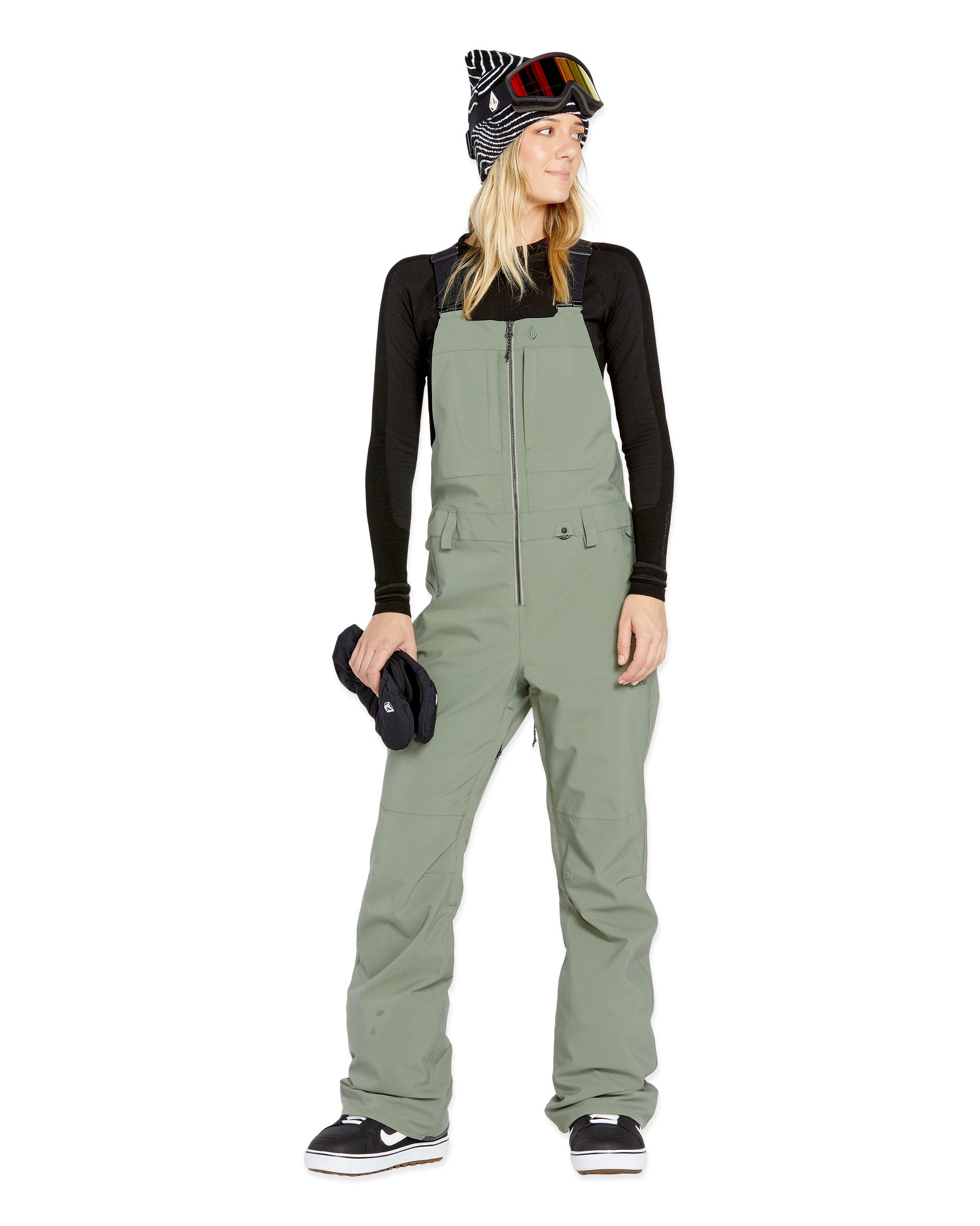 Volcom Women's Swift Bib Overall - A sage green bib overall with a zippered front and two side pockets, featuring a small white logo on the left thigh.