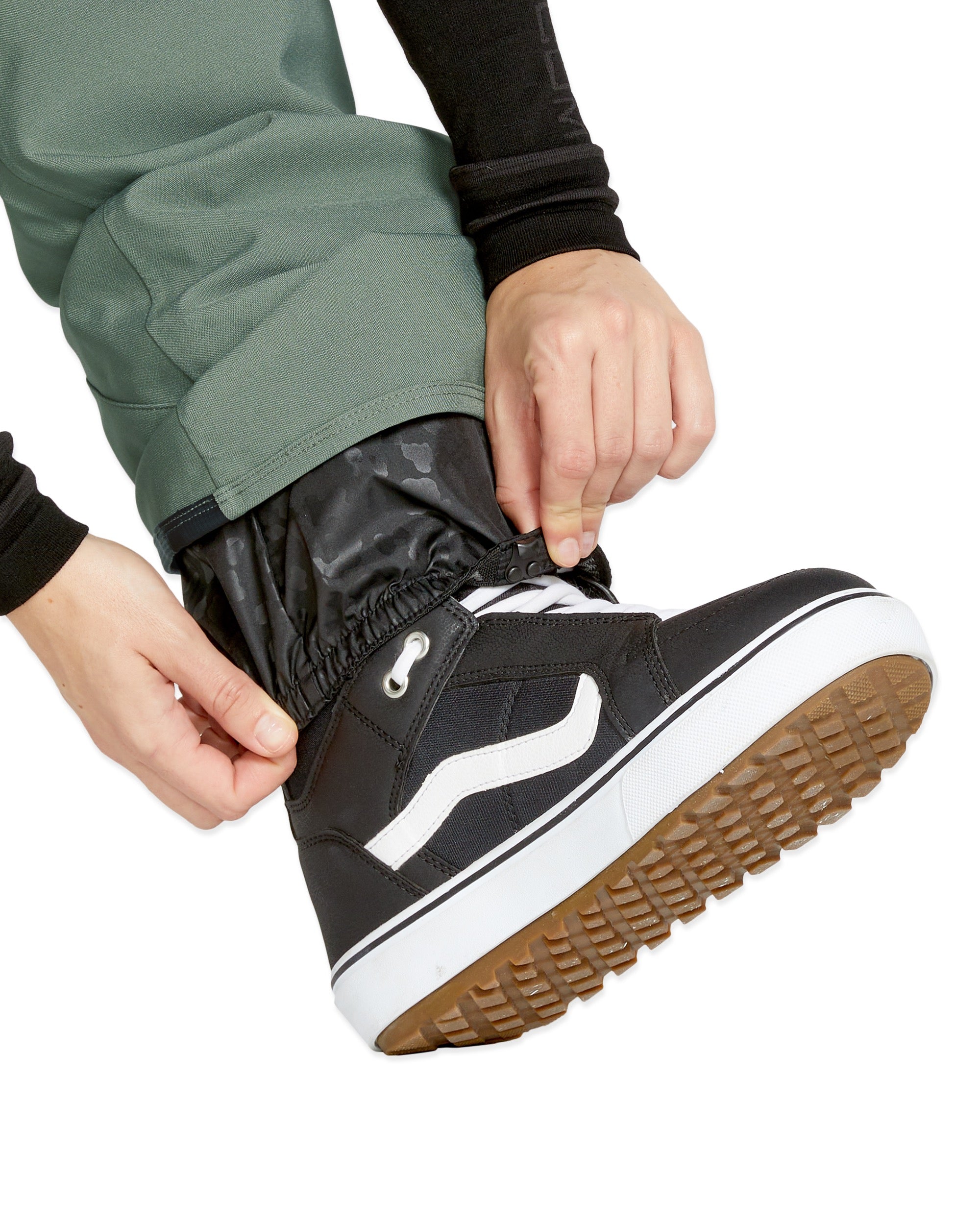 Volcom Women's Swift Bib Overall - A pair of black snow pants with a subtle white pattern and a zippered pocket on the thigh.