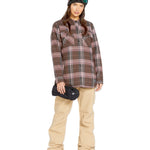 Volcom Women's Swift Bib Overall - A brown overall with a white stripe on the side of the leg and two zippered pockets at the front.