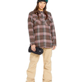 Volcom Women's Swift Bib Overall - A brown overall with a white stripe on the side of the leg and two zippered pockets at the front.
