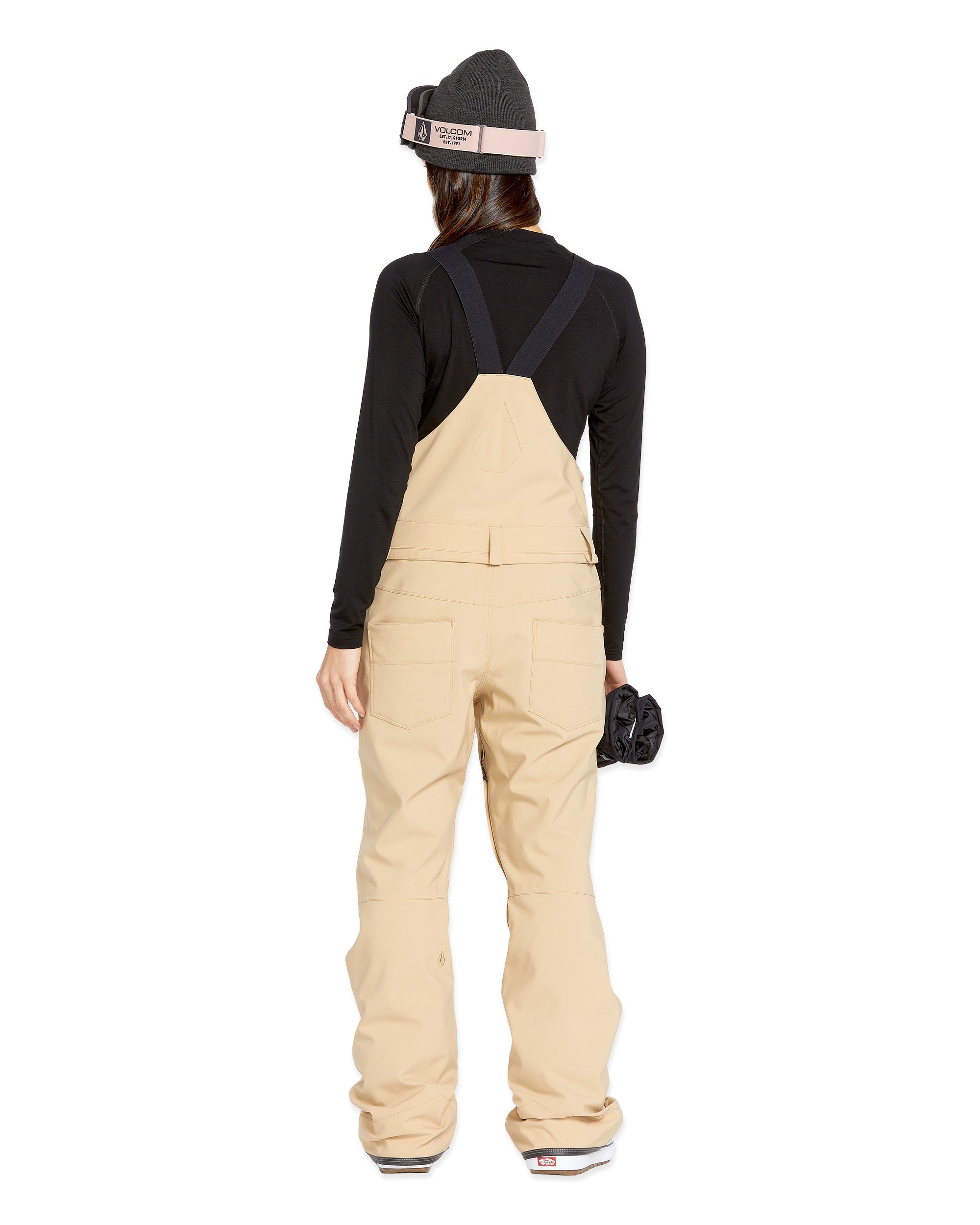 Volcom Women's Swift Bib Overall - Beige bib overalls with a black strap and buckle on the back, featuring two front pockets.