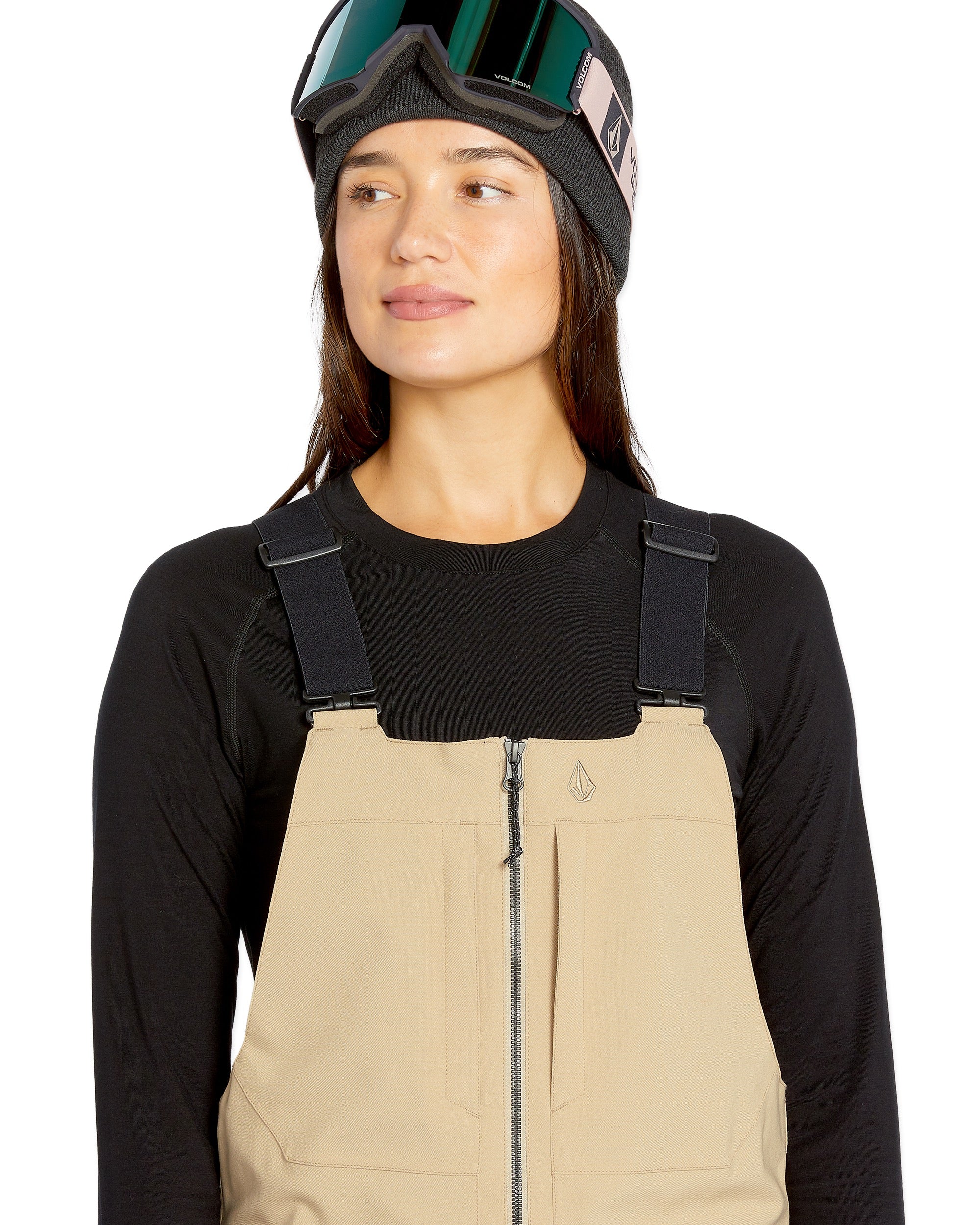 Volcom Women's Swift Bib Overall - A pair of khaki bib overalls with a zip front and adjustable straps.