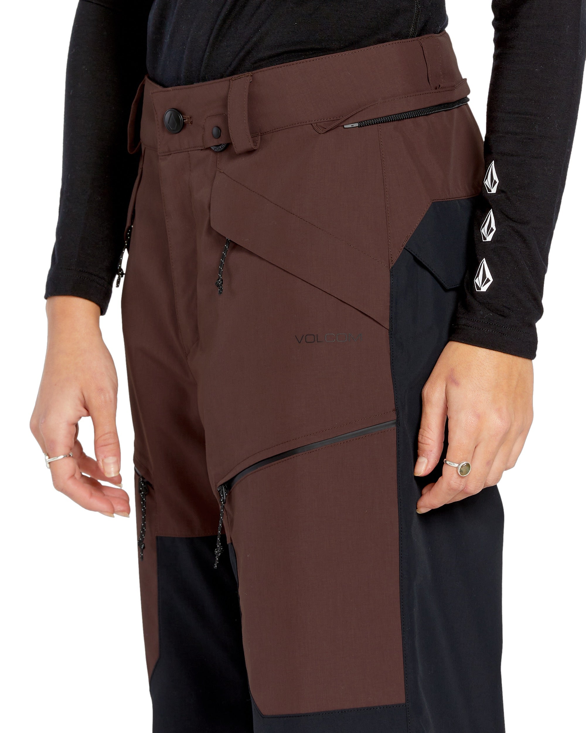 Volcom Women's Stone Mica 20K Pant - A pair of brown ski pants with a black stripe down the side and a zippered pocket on the thigh.