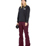 Volcom Women's Genus Stretch Pant 2025 - Black snow pants with a subtle white logo on the left thigh and zippered pockets at the hips.
