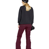 Volcom Women's Genus Stretch Pant 2025 - A black ski pant with a white logo on the left thigh and zippered pockets.