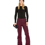 Volcom Women's Genus Stretch Pant 2025 - A pair of maroon snow pants with a zippered pocket on the side and a button fly.