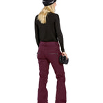Volcom Women's Genus Stretch Pant 2025 - A pair of maroon snow pants with a zippered pocket on the right thigh and black zippers at the ankles.