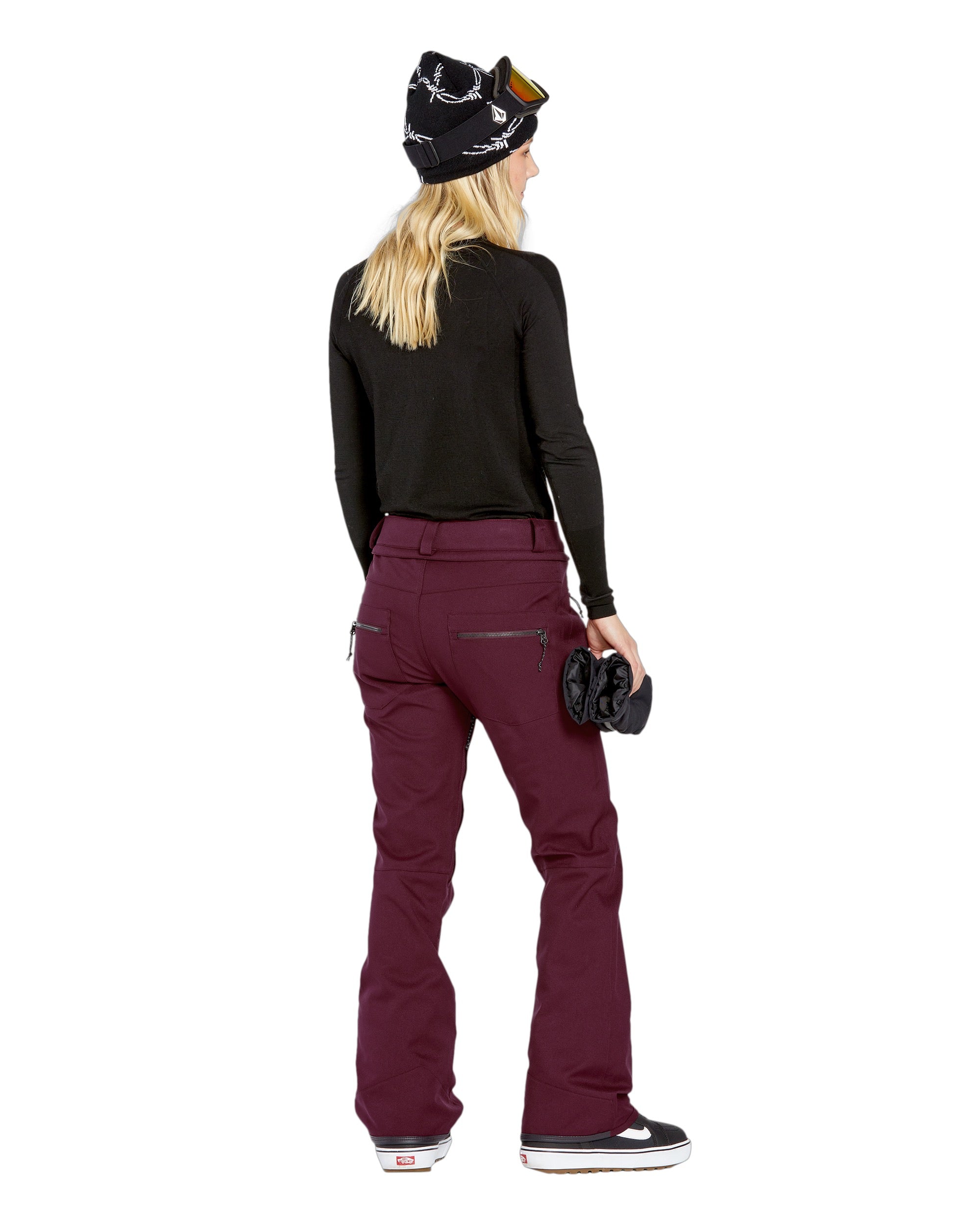 Volcom Women's Genus Stretch Pant 2025 - A pair of maroon snow pants with a zippered pocket on the right thigh and black zippers at the ankles.