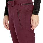 Volcom Women's Genus Stretch Pant 2025 - A pair of maroon snow pants with a zippered pocket on the side and a black zipper pull.