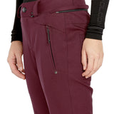 Volcom Women's Genus Stretch Pant 2025 - A pair of maroon snow pants with a zippered pocket on the side and a black zipper pull.