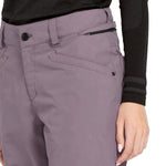Volcom Women's Hallen Shell Pant 2025 - A pair of light purple snow pants with a zippered pocket on the side and a black zipper pull.