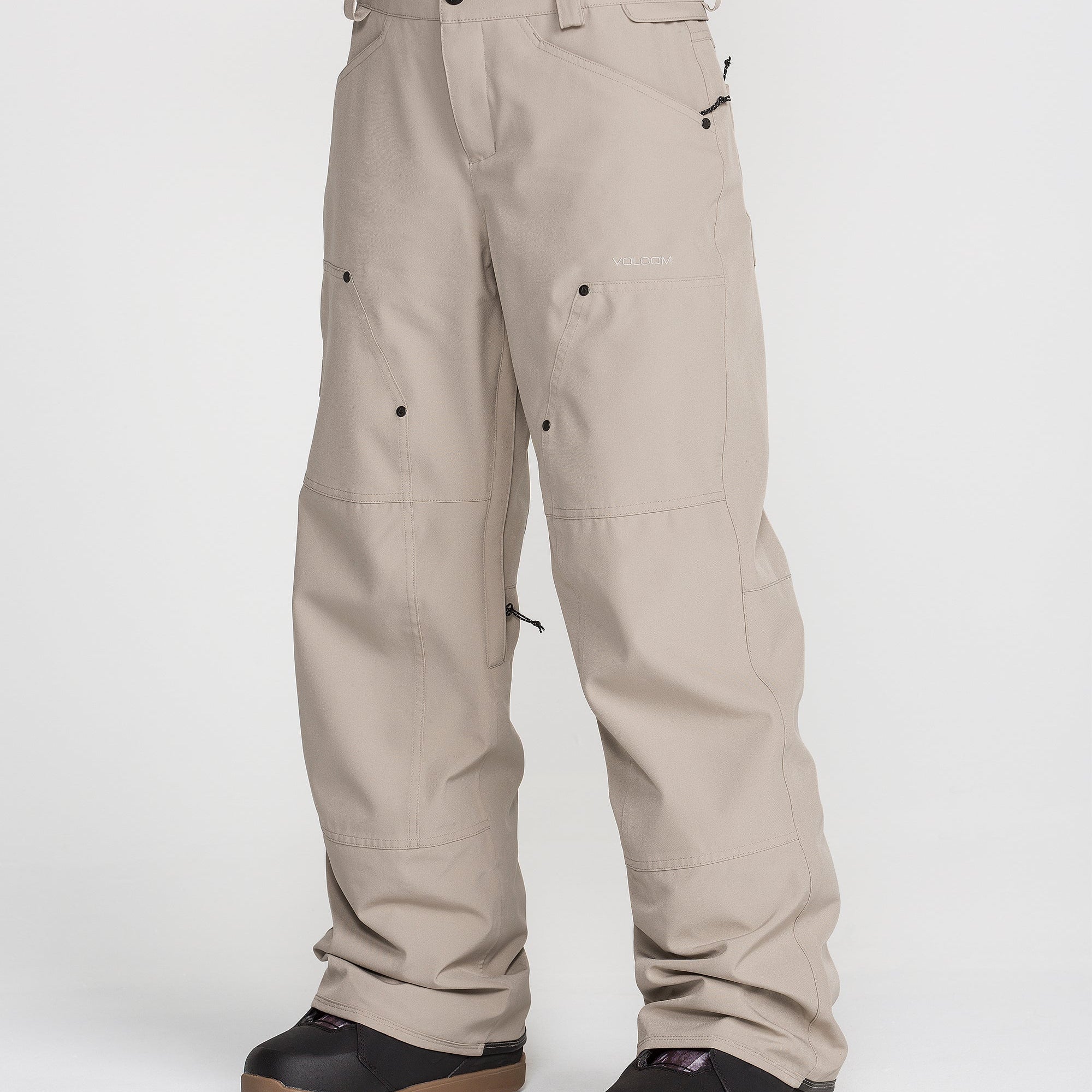 Women’s baggy cargo snow pants in light khaki, front button and side pockets.
