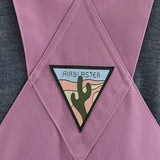 Airblaster Women's Hot Bib Shell 2025 - A pink snow bib shell with a white logo on the left chest and a black zipper running down the front.