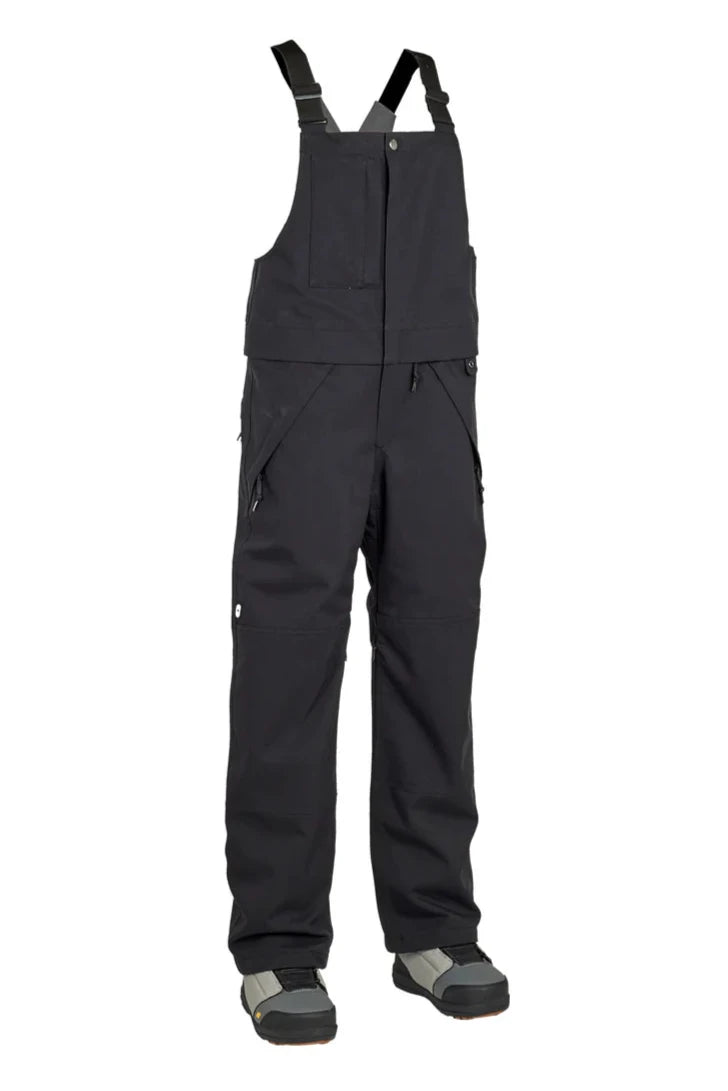 Airblaster Women's Hot Bib Insulated 2025 - Black bib overalls with zippered front and adjustable straps, featuring a large pocket on the right thigh.