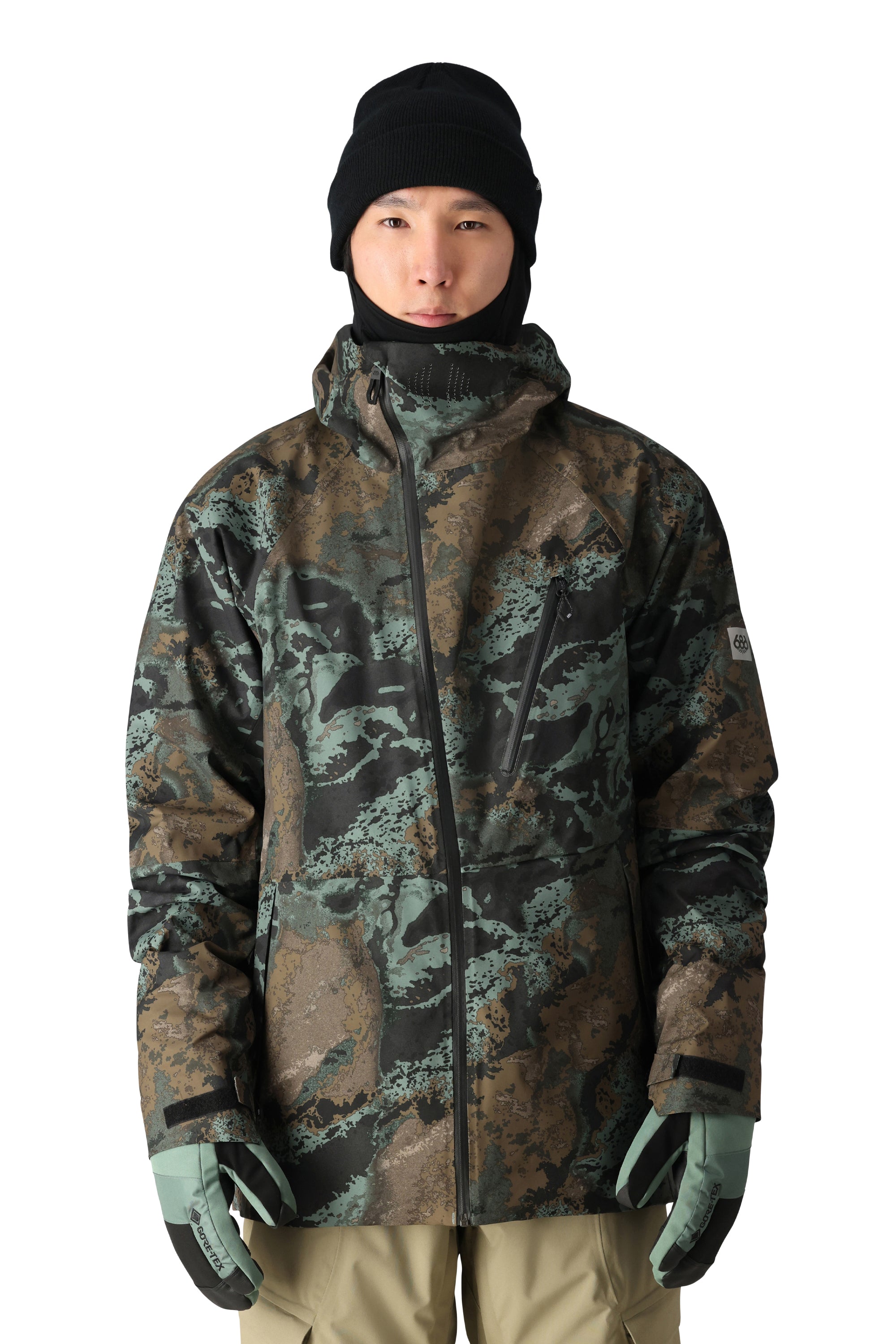 The 686 Hydra Thermagraph jacket in camouflage print appears to be made of waterproof material and has an insulated hood.