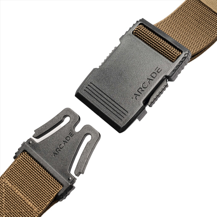 A close-up of the light brown belt's unfastened buckle. The black plastic buckle parts are separated, showing the hook mechanism on one side and the slot on the other, with "ARCADE" embossed on the hook side.