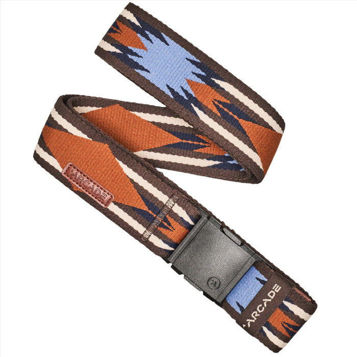 A belt with a geometric pattern in brown, blue, and white. The belt features zigzag and diamond shapes, with a plastic buckle. There is a small rectangular tag with 'Arcade' written on it.