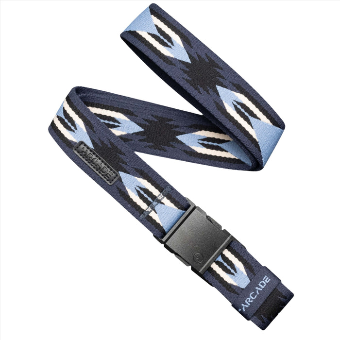 A navy blue belt with a geometric pattern in light blue, black, and white, laid flat with a black plastic buckle. The belt has a leather tag with the word 'Arcade' stitched on it.