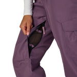 Black plum cargo pants showing side pocket opening and layered panel construction