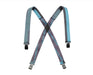 A pair of suspenders featuring a crisscross pattern in shades of blue and grey. The suspenders have the text 'STRAP IN. VENTURE OUT.' printed in blue on the grey section and black clasps at the ends.