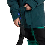 Burton Junior's Ascutney 2L Insulated Jacket 2025 - A dark green jacket with a blue logo on the left chest and two zippered pockets on the front.