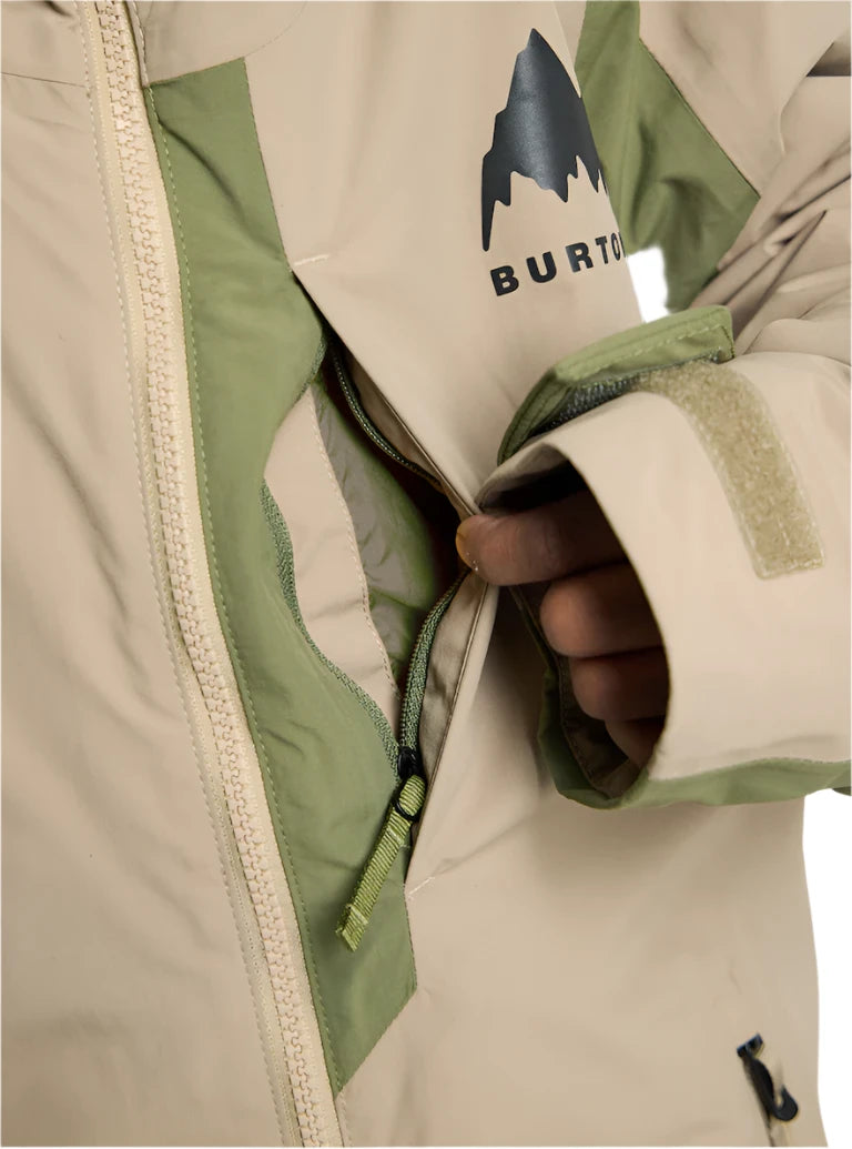 Burton Junior's Hillslope Insulated Jacket 2025 - A cream-colored jacket with a green stripe on the sleeve and a black logo featuring a mountain peak above the word "BURTON".