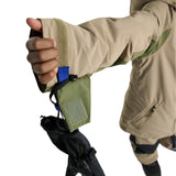 Burton Junior's Hillslope Insulated Jacket - A tan jacket with a green stripe on the sleeve cuff and a blue tag sewn onto it.