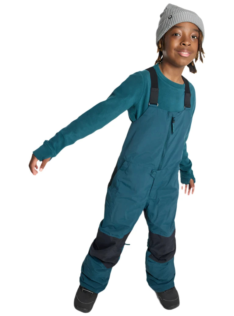 Burton Junior's Skylar 2L Bib Pant 2025 - A pair of dark blue snow pants with a black strap and buckle on the waist, featuring a small logo on the left thigh.