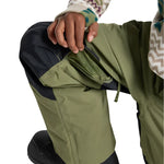 Burton Junior's Skylar 2L Pant 2025 - A pair of olive green snow pants with black accents and a zippered pocket on the side.