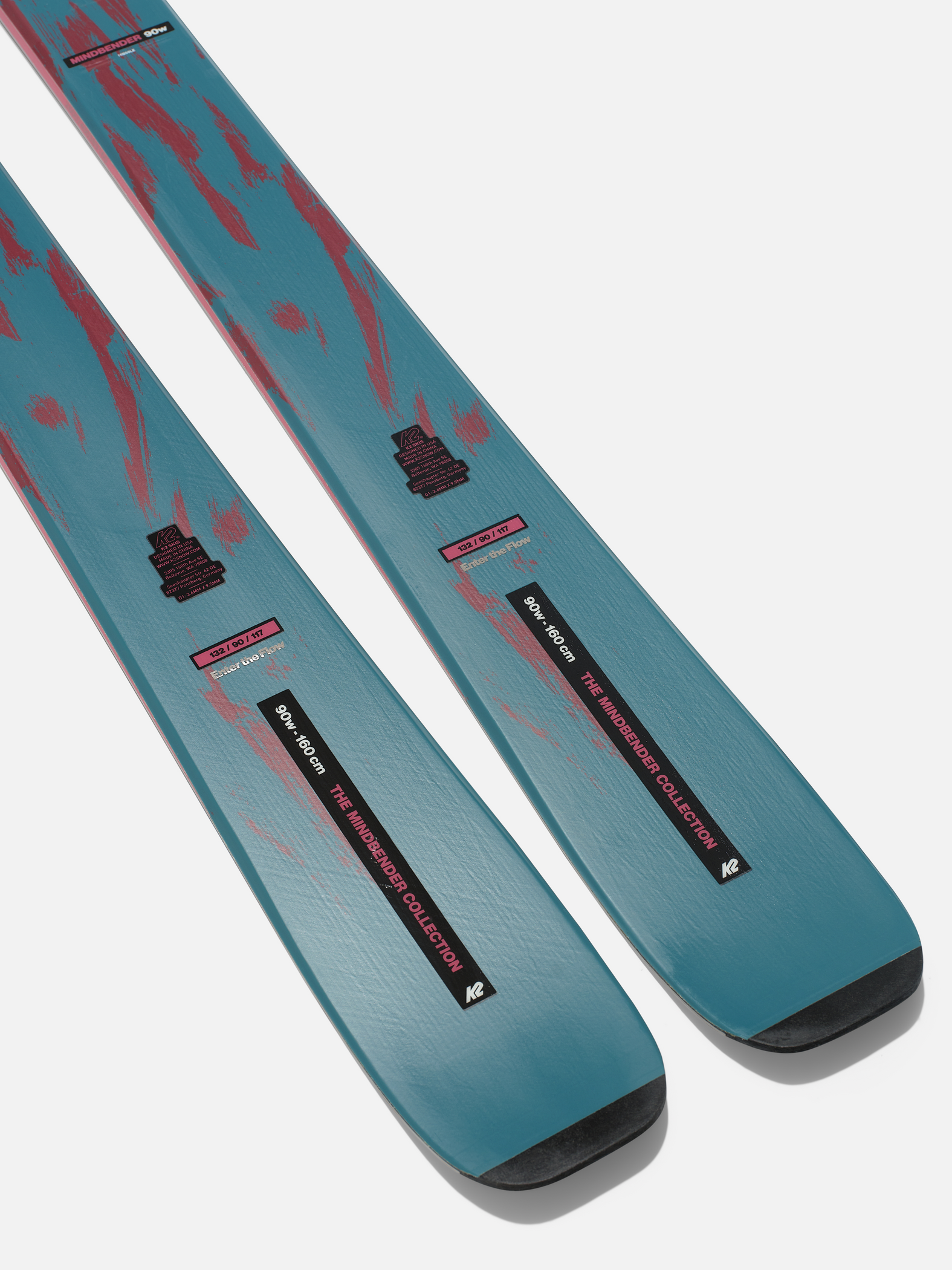 Pair of teal and red graphic skis with black tips and bindings