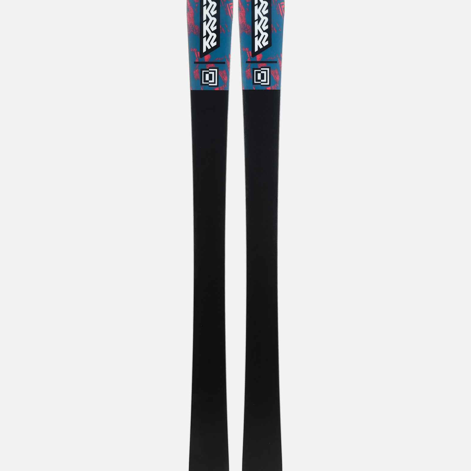 Pair of skis showing black bases with teal and pink tops